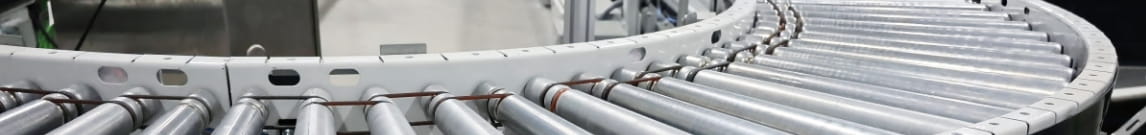 Two-level roller conveyor curve in a warehouse picking area.
