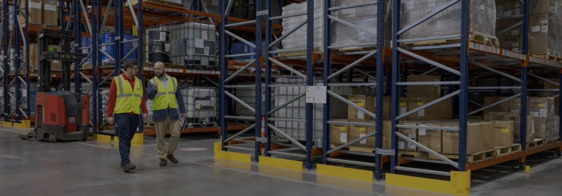 RSC representative consulting with a customer during a warehouse racking assessment.