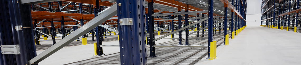 Warehouse aisle highlighting structural column and racking protection.