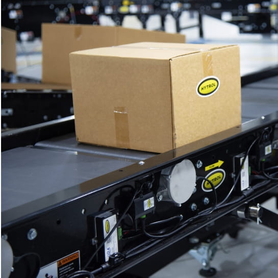 Hytrol accumulation conveyors transporting boxes along an automated material handling line.