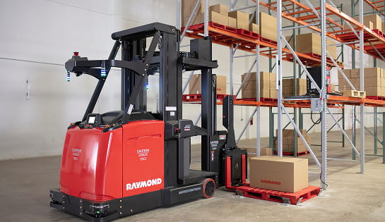 Raymond AVG swing reach truck moving a pallet into a racking.