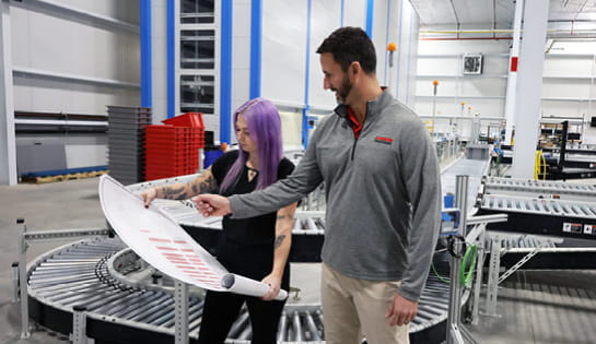 RSC engineers review blueprint for warehouse automation project.