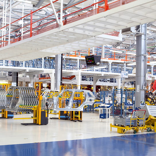 Automotive side car frames positioned along an assembly line in a modern manufacturing facility.