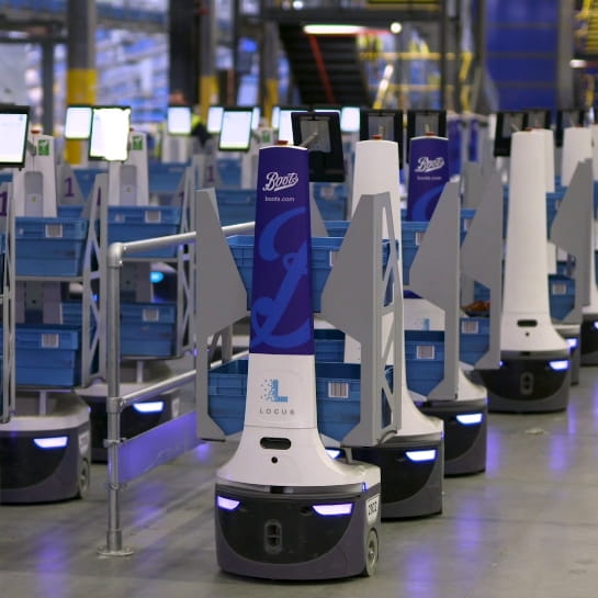 Locus autonomous mobile robots transporting orders to warehouse personnel.