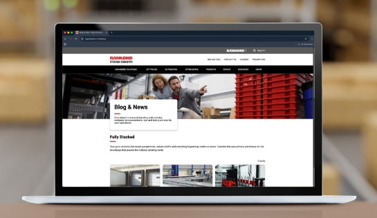 Laptop displaying the RSC blog with a warehouse in the background.