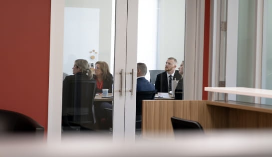 Corporate team holding a strategy discussion in an office conference room.