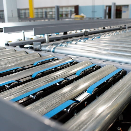 Automated package sorting diverter operating within a distribution center conveyor line.