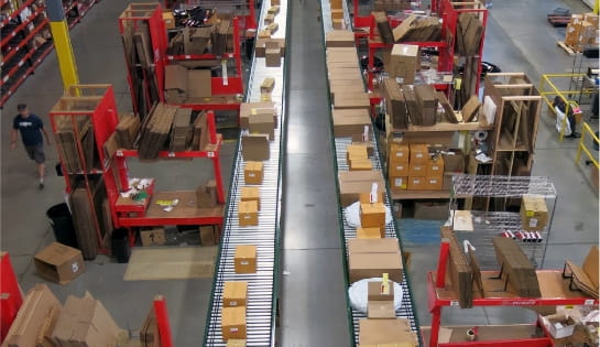 Accumulation conveyor system operating with pickers packing orders at Specialized Bicycle Components distribution center.