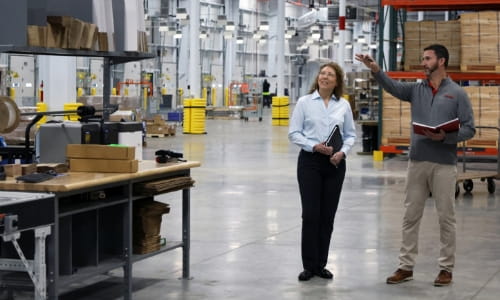 RSC sales engineer discussing warehouse operations with a customer on-site.