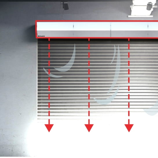 Air curtain diagram illustrating airflow patterns and thermal barrier protection at a loading dock door.