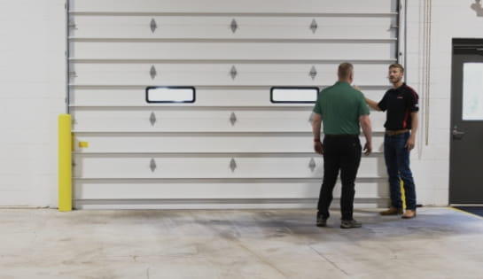 RSC Dock & Door specialist consulting with a client on commercial sectional door solutions.