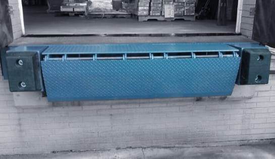 Edge-mounted dock leveler installed at a warehouse loading bay.