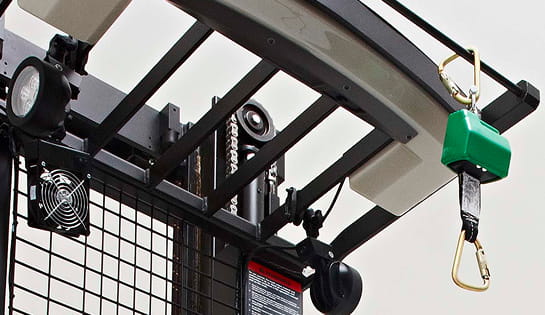 Close-up of a forklift overhead guard with an active fall protection tether attached