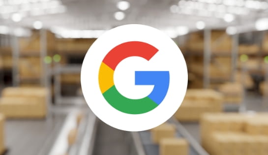 Google G icon overlaid on a blurred warehouse background featuring boxes, conveyors, and racking