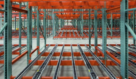 Pallet flow gravity flow racking loaded with inventory in a warehouse