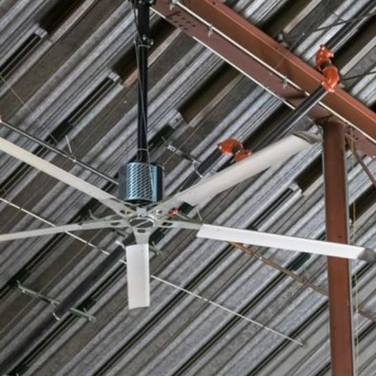 Large-diameter HVLS fan hanging from a high warehouse ceiling for climate control