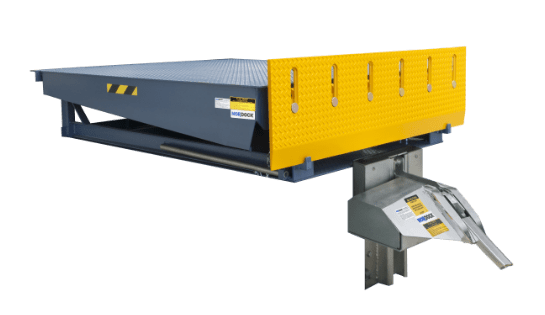 Gray and yellow hydraulic dock leveler installed in a warehouse loading bay