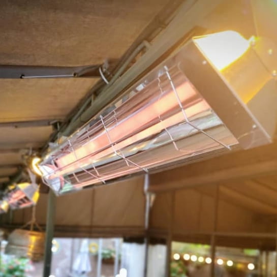 Infrared heaters mounted to the ceiling of an industrial building for localized climate control