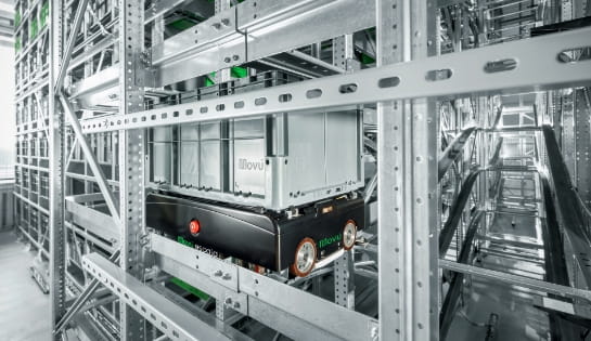 Close-up of a Movu shuttle cart carrying a box inside a high-density pallet shuttle racking system
