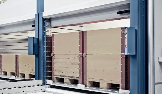 Two loaded pallets stored inside a large Kardex automated storage and retrieval system
