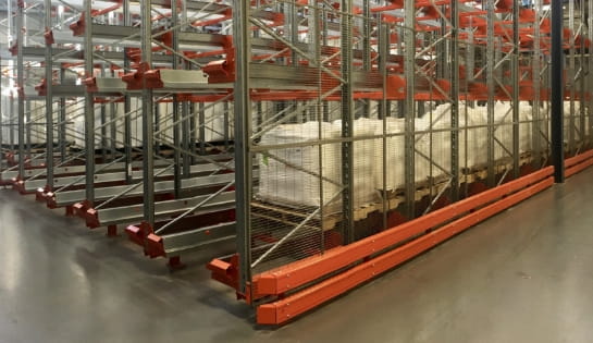 Multiple loaded pallets stored within a semi-automated pallet racking system powered by Radioshuttle