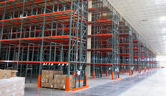 Multiple aisles of newly installed pallet rack in a Central Ohio retail warehouse