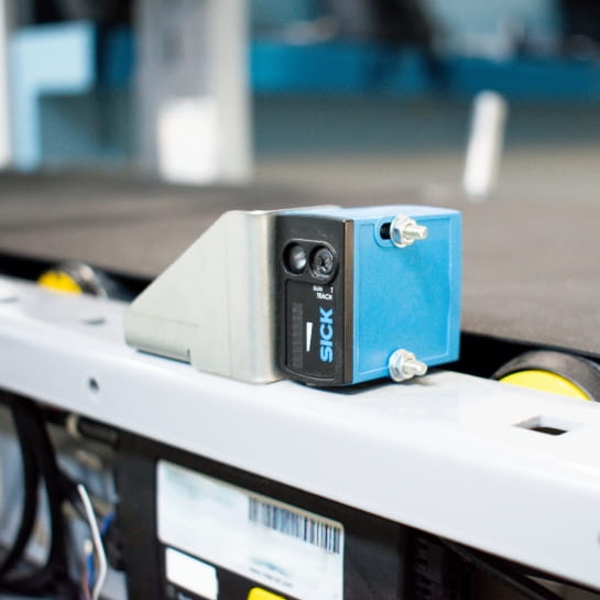 SICK motion sensor attached to an industrial conveyor system