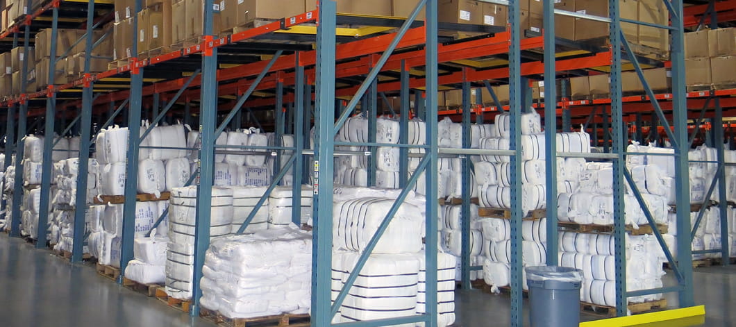 After view of bales and pallets efficiently organized in push back pallet rack systems at Standard Textile