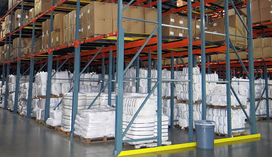 After view of bales and pallets efficiently organized in push back pallet rack systems at Standard Textile