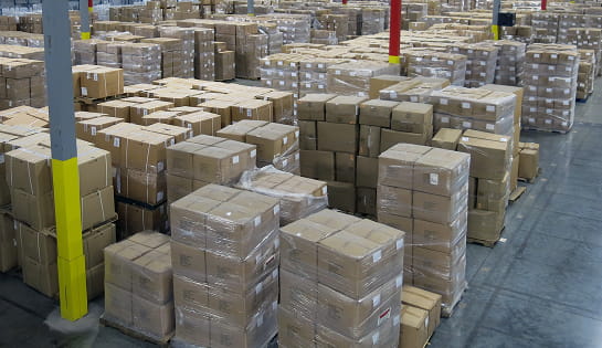 Before view of stacked pallets crowding the storage floor at the Standard Textile warehouse