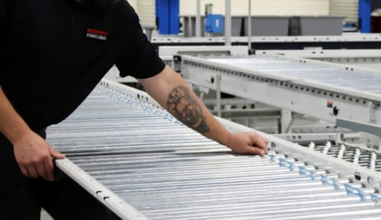 Raymond Storage Concepts technician checking O-bands on a conveyor belt system