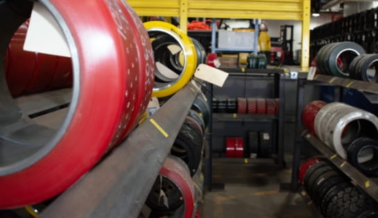 Row of forklift tires lined up on warehouse shelves at the Raymond Storage Concepts Cincinnati branch