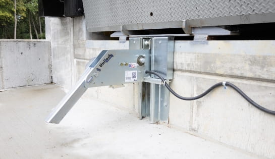 Close-up of a vehicle restraint installed in a dock pit for warehouse safety