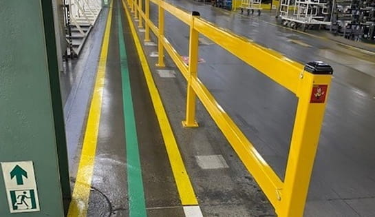 Save-ty Yellow Products safety guardrail separating a designated pedestrian walkway from an active warehouse traffic zone